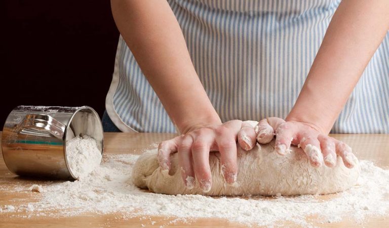 Hands kneading dough